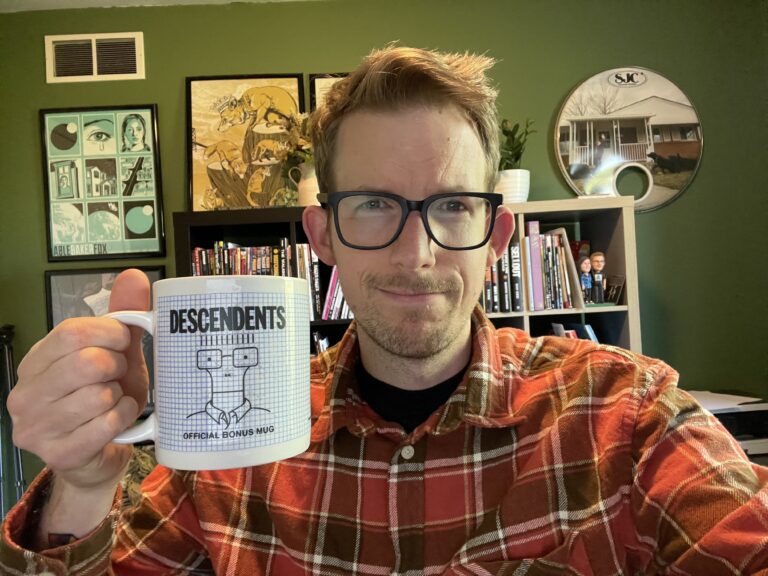 Jono. KARMA jack's Vice President, holding a cup of coffee.