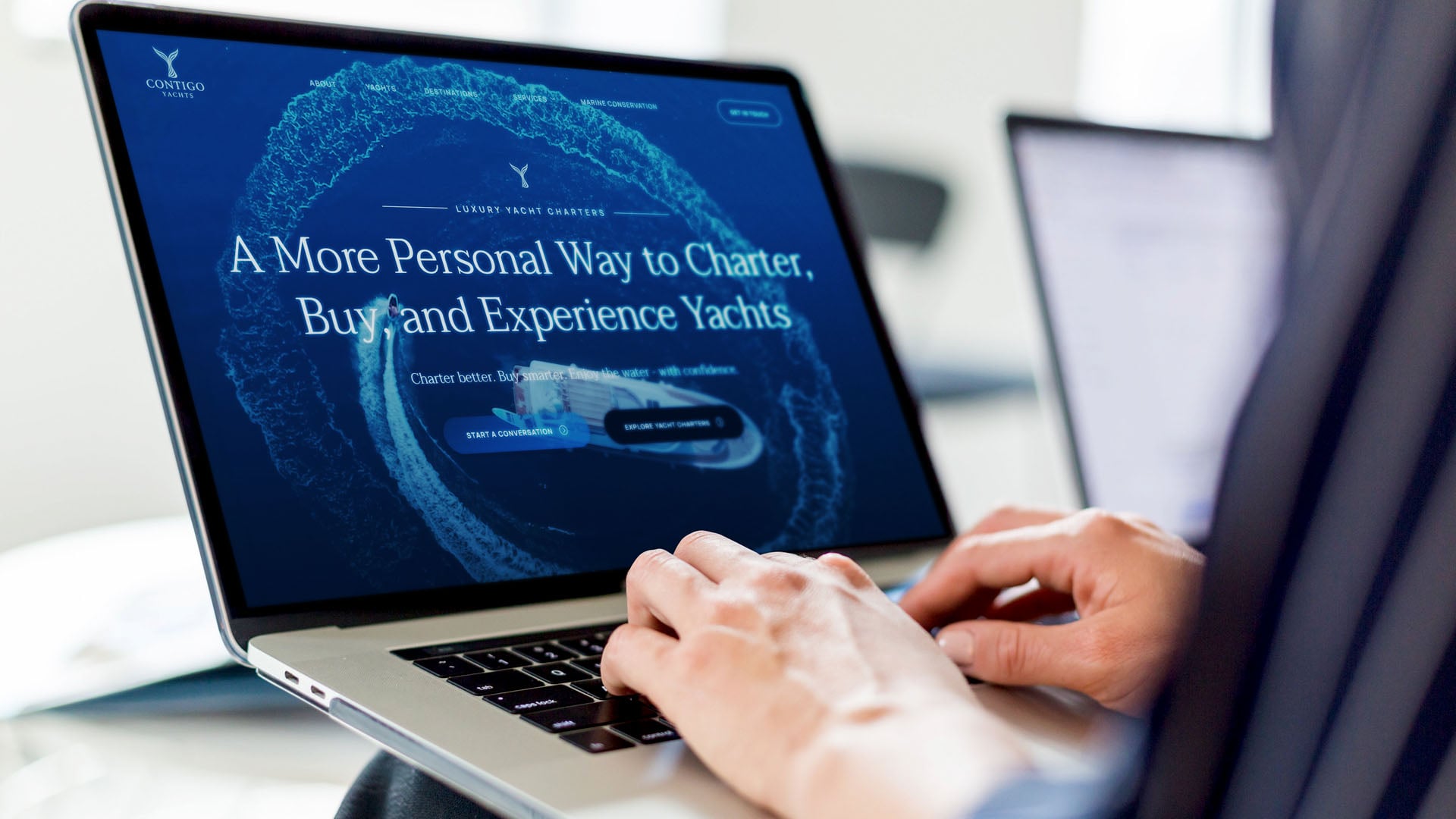 Contigo Yachts website on a laptop